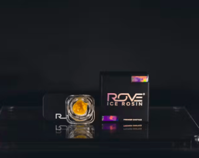 Black Rove Diamonds box with mint corner accents beside a clear glass jar of amber crystalline concentrate, the packaging used for Gas Runtz